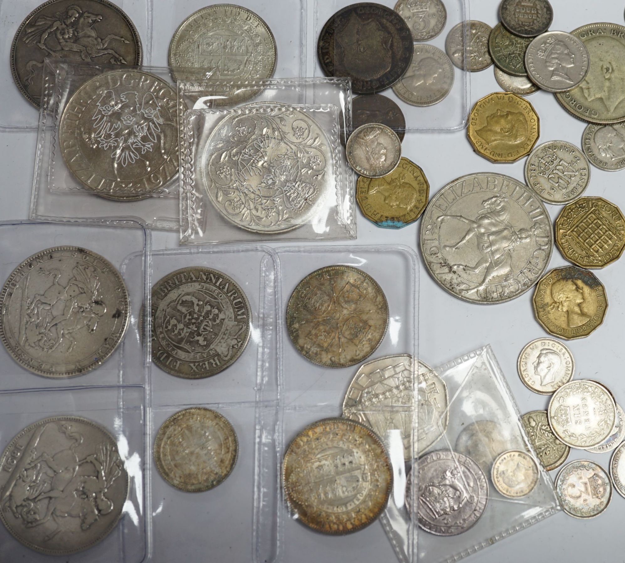A group of UK coins including 1819, 1821 and 1891 crowns, two 1887 half crowns, 1887 florin, etc.